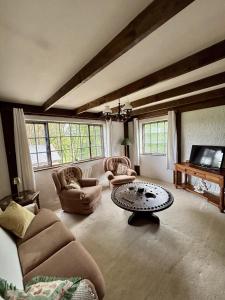 a large living room with couches and a table at Bay View Ridge Cottage in Bantry