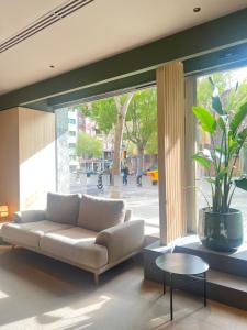 a living room with a couch and a large window at Hotel Sant Pau in Barcelona