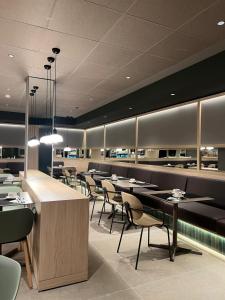 a restaurant with tables and chairs in a room at Hotel Sant Pau in Barcelona
