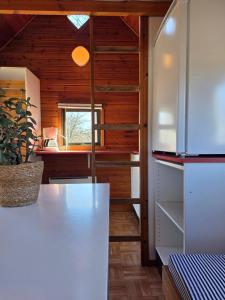 a kitchen with a white refrigerator and a window at Nivå Camping & Glamping in Nivå