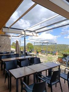 a group of tables and chairs in a restaurant with a view at Cor De Prades in Mont-ral