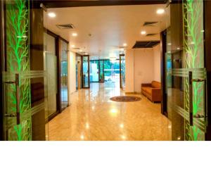 a hallway of a building with a couch in the distance at Goyal Hotelirs - Hotel The Agra Grande, Agra in Agra