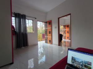 a living room with a laptop computer on a table at The Long Stay Goa in Arambol