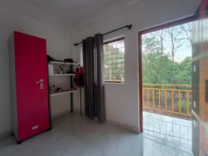 a room with a door and a large window at The Long Stay Goa in Arambol
