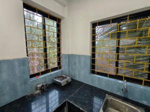 a bathroom with a sink and a window at The Long Stay Goa in Arambol +18 photos