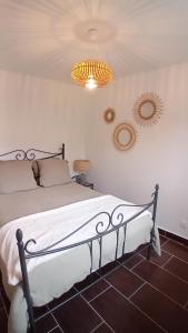 a bedroom with a bed and two mirrors on the wall at Mini-maison indépendante vue montagne- Corse in Poggio-Marinaccio