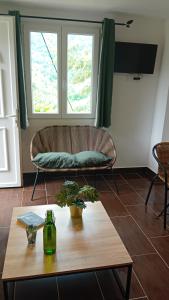 a living room with a couch and a coffee table at Mini-maison indépendante vue montagne- Corse in Poggio-Marinaccio