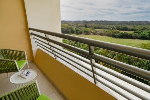 a balcony with a view of a golf course at Iberostar Selection Playa Mita - All Inclusive in Punta Mita