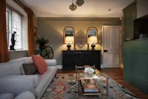 a living room with a couch and a coffee table at The Gatehouse in Peterborough