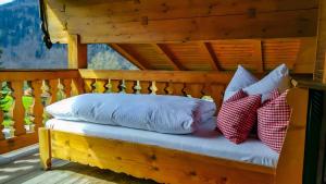two pillows sitting on a bench on a porch at Haus Sunnleitn Vogelsang in Bayrischzell
