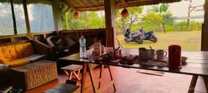 a room with a table and a motorcycle in the background at Caban Zenfants in Sainte Marie
