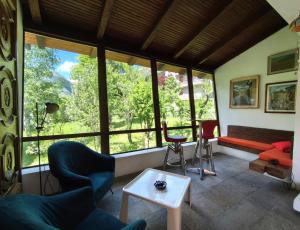 a living room with a couch and chairs and a table at Ca di Nà in Entracque +33 photos