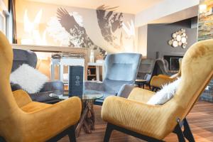 a waiting room with chairs and a table at Le Grand Aigle, Friendly Hotel & Spa in La Salle-les-Alpes