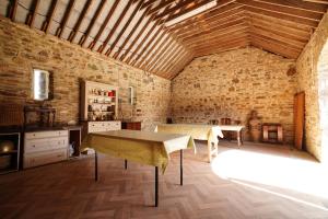 a dining room with a table and a brick wall at Rockfield House in Kells