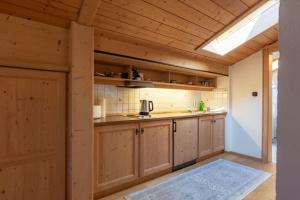 a kitchen with wooden cabinets and a skylight at Haus Sunnleitn Vogelsang in Bayrischzell