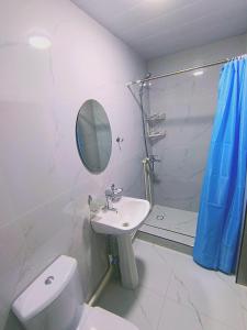 a bathroom with a sink and a toilet and a mirror at Hotel Nazira & Azizbek in Bukhara +13 photos