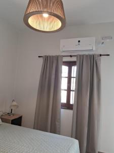 a bedroom with a bed and a window at CASABLANCA CATAMARCA Guest House in San Fernando del Valle de Catamarca