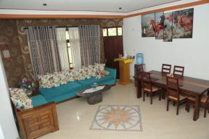 a living room with a blue couch and a table at Joyous Cottage in Maharagama +9 photos