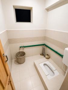 a bathroom with a toilet and a sink at Highlander inn Skardu in Skardu