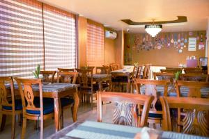 a restaurant with tables and chairs in a room at The R One in Male City