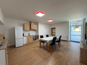 a kitchen and dining room with a table and chairs at Patrycja 2 in Ehenbichl