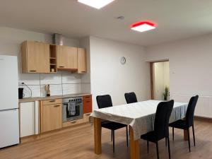 a kitchen and dining room with a table and chairs at Patrycja 2 in Ehenbichl +20 photos