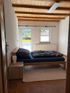 a bed in a small room with a window at Patrycja 2 in Ehenbichl