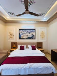 a bedroom with a large bed with a ceiling at Hotel Kalptaru Villas in Debāri