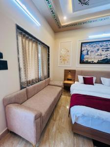 a living room with two beds and a couch at Hotel Kalptaru Villas in Debāri