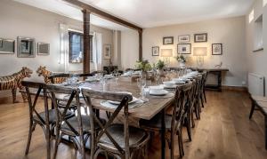 a large dining room with a long table and chairs at The Lady Rothschild Stables in Peterborough