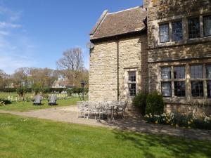 a table and chairs sitting outside of a building at Greenwood Manor in Peterborough +19 photos
