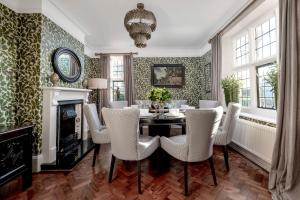 a dining room with a table and chairs and a fireplace at Greenwood Manor in Peterborough