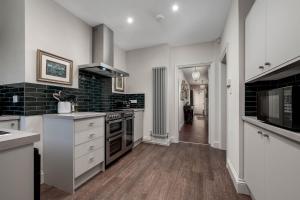 a kitchen with white counters and a stove top oven at Greenwood Manor in Peterborough
