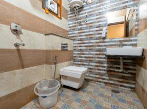 a bathroom with a toilet and a sink at Boho Stays Rishikesh in Rishīkesh