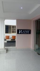 a sign on the wall of a building at Kris Courts in Ibadan