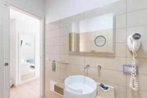 a bathroom with a sink and a mirror at Hotel Perla Gaia in San Vito lo Capo +79 photos