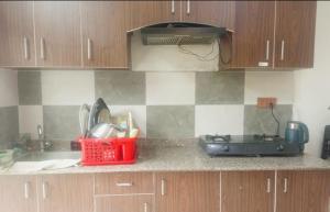 a kitchen with a counter top with a sink and a counter top at Kiyo's Apartment in Bālāju