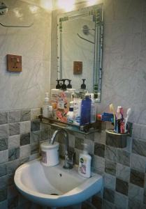 a bathroom with a sink and a mirror at Kiyo's Apartment in Bālāju