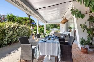 a table and chairs on a patio at Hotel Le Golfe Bleu in Cavalaire-sur-Mer