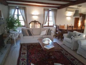a living room with a white couch and a table at Cascina Benotto in Moriondo Torinese