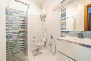 a bathroom with a shower and a toilet and a sink at Fiordaliso in Alba Adriatica +21 photos