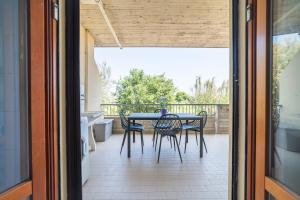 a patio with a table and chairs on a balcony at Fiordaliso in Alba Adriatica