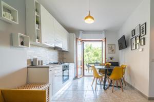 a kitchen and dining room with a table and chairs at Fiordaliso in Alba Adriatica