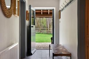 a hallway with a door leading to a yard at Home Farm Cottage in Peterborough