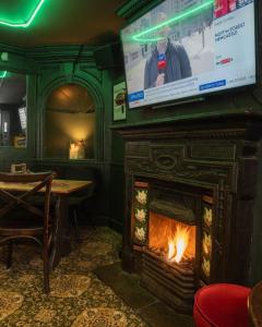 a fireplace with a television on top of it at The Hairy Lemon in Alnwick