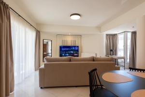 a living room with a couch and a table at MAREL Luxury Residence Malia in Malia