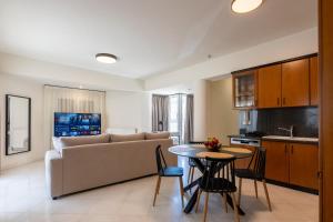 a living room with a couch and a table at MAREL Luxury Residence Malia in Malia
