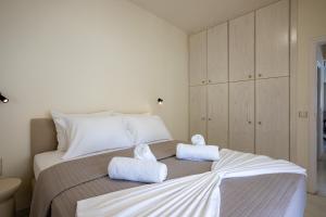 a bedroom with a bed with towels on it at MAREL Luxury Residence Malia in Malia