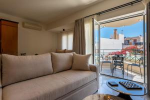 a living room with a couch and a balcony at MAREL Luxury Residence Malia in Malia