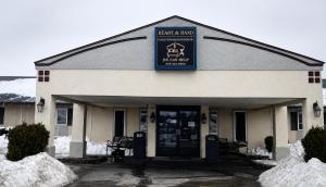 a building with a sign on the front of it at Home Suites in Thief River Falls